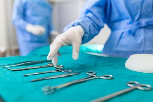 nurse-hand-taking-surgical-instrument-group-surgeons-background-operating-patient-surgical-theatre-steel-medical-instruments-ready-be-used-surgery-emergency-concept